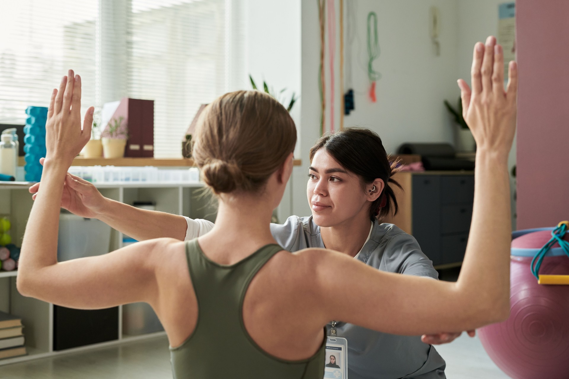 Practicing Yoga with Instructor in Modern Studio Setting